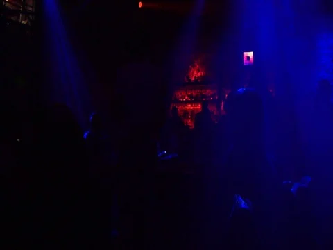 Silhouettes of people dancing in a dimly lit bar night time. Stock Footage 89370893