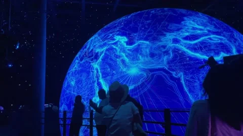 Silhouettes of people in front of the planet model Video stock 163079277
