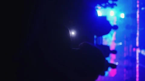 Silhouettes of people jumping, waving, taking photos or recording videos of a li Vídeo Stock 258345069