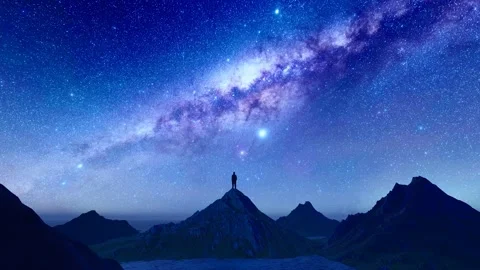 Silhouettes of people looking up at the starry sky on the top of the mountai Stock Footage 250502876