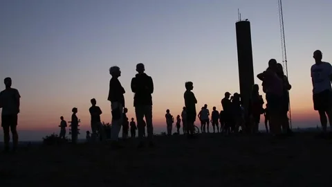 Silhouettes of people looking at the sunset Stock Footage 220930475
