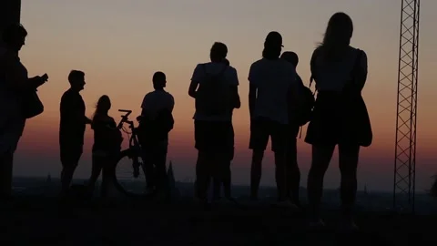 Silhouettes of people looking at the sunset Stock Footage 220930477