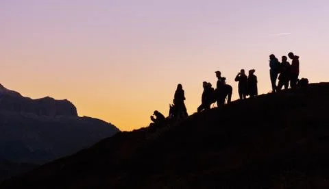 Silhouettes of people on mountains Stock Photos