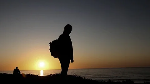 Silhouettes of people by the ocean Stock Footage 123200380