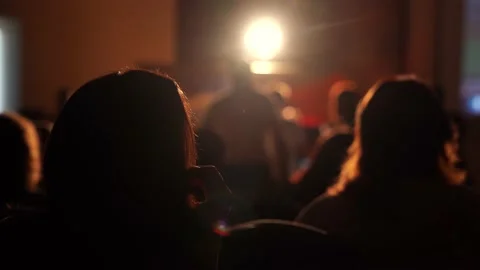 Silhouettes of people sitting in the hall on the performance Stock Footage 155115798