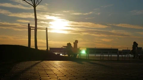 Silhouettes of people on the sunset Stock Footage 83634094