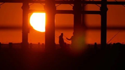 Silhouettes of people in the sunset Stock Footage 85443100