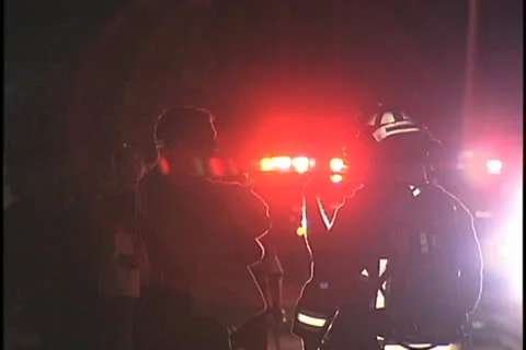 Silhouettes of People Talking in Front of a Fire Truck Video stock 26178847