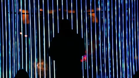 Silhouettes of people under blue light strips Stock Footage 329952207