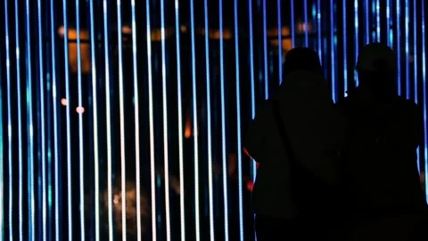 Silhouettes of people under blue light strips Stock Footage 329952215