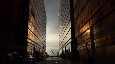 Silhouettes of people walking between two glass buildings in Hong Kong Stock Footage 259873133