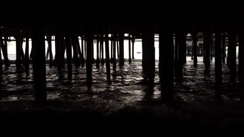 The silhouettes of the pillars under the pier; Stock Footage 234067514