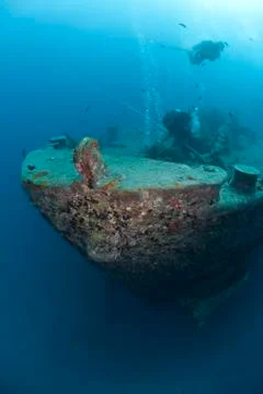 Silhouettes of scuba divers exploring the bow of a shipwreck. red sea, egypt. Stock Photos