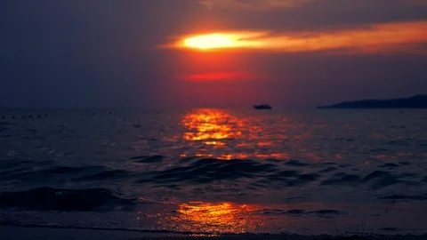Silhouettes, seascape, red dramatic sunset on the sea. the sun paints the sea Stock Footage 99528108