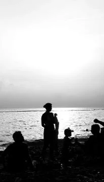 Silhouettes at the seaside Stock Photos