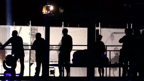Silhouettes of several people dancing on the balcony Stock Footage 140222779