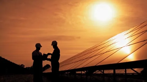 Silhouettes of Solar Panel Workers at Sunset Stock Footage 276289724