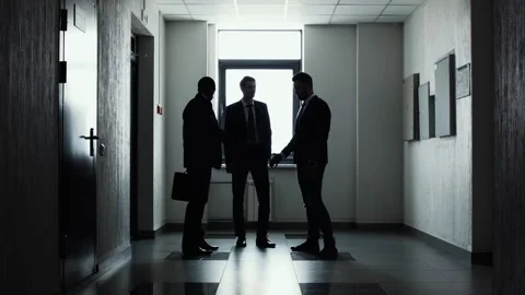 Silhouettes of three businessmen. Handshake. Stock Footage
