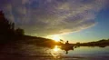 Silhouettes of tourists boating at sunset. Majestic landscape HD Footage