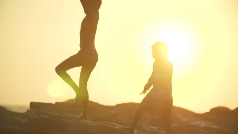Silhouettes of two happy children at sunset Stock Footage 84883161