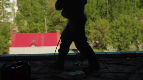 Silhouettes of two workers welding a beam Stock Footage 57725158