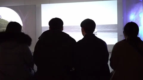 Silhouettes watching projectors Stock Footage