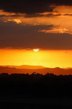 Silhouettes of windmill in sunset time Foto stock