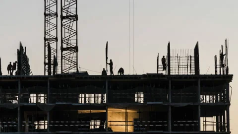 Silhouettes of workers-installers on the construction of the building Stock Footage 105760331