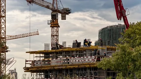 Silhouettes of workers-installers on the construction of the building, time l Stock Footage 160340968