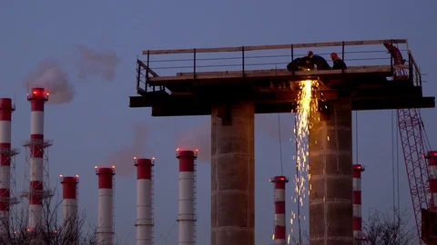 Silhouettes of workers-installers  working on a column, a support for an auto Stock Footage 125252343