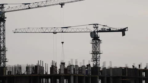 Silhouettes of working cranes during the construction of a high-rise building Stock Footage 152135383