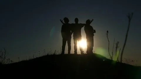 Silhouettes Of Young Men Having Fun And Posing For A Picture In Sunset Time Stock Footage 87988249
