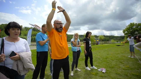 SILICHY, BELARUS - 2, AUGUST, 2019: A man in an orange T-shirt actively supports Stock Footage 129951941