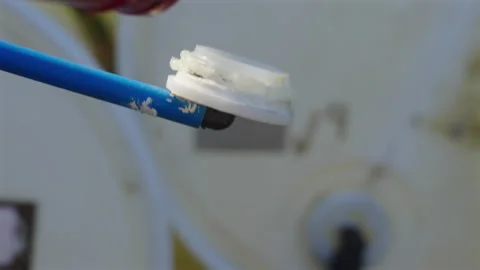 Silicon applied to sealing airvent before install, close up Stock Footage 337442535