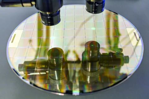 Silicon wafer on machine process examining in microscope. Stock Photos
