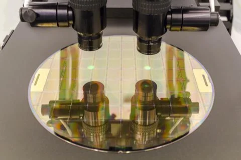 Silicon wafer on machine process examining in microscope. Stock Photos