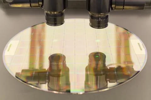 Silicon wafer on machine process examining in microscope. Stock Photos