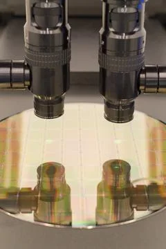 Silicon wafer on machine process examining in microscope. Stock Photos