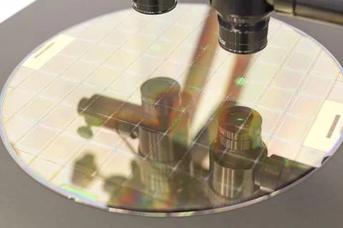 Silicon wafer on machine process examining in microscope. Stock Photos
