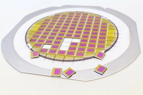 Silicon wafer with microchips fixed in a holder with a steel frame after the Stock-Fotos