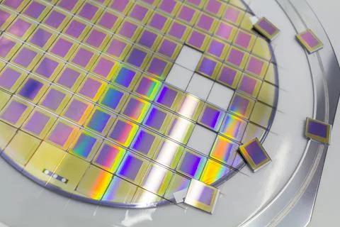 Silicon wafer with microchips fixed in a holder with a steel frame after the Stock-Fotos