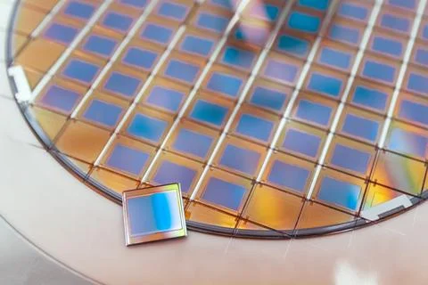 Silicon wafer with microchips fixed in a holder with a steel frame after the Stock-Fotos