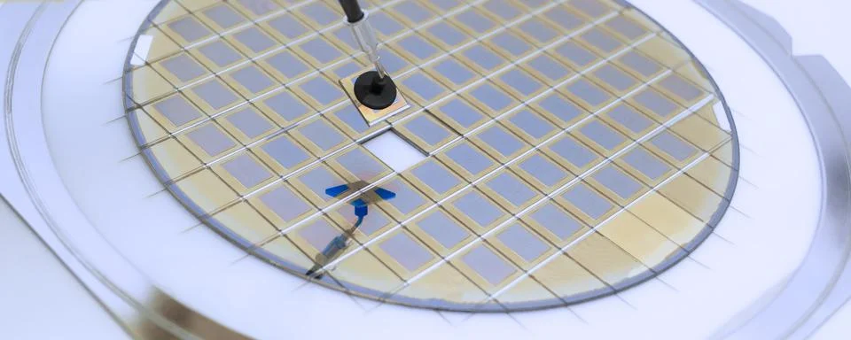 Silicon wafer with microchips fixed in a holder with a steel frame after the  Stock Photos