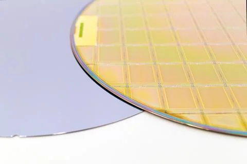 Silicon Wafers two types -empty grey wafer and gold wafes with microchips Stock Photos