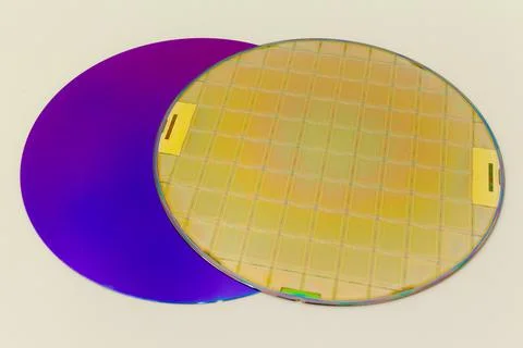 Silicon Wafers two types -empty grey wafer and gold wafes with microchips Stock Photos