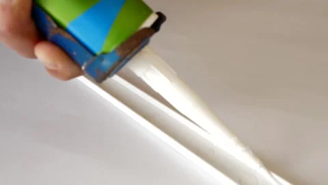 Silicone is applied to the window sill cap for installation. Construction works. Stock Footage 252200472