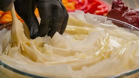 Silicone brush greases rolled phyllo dough Stock Footage 328093498