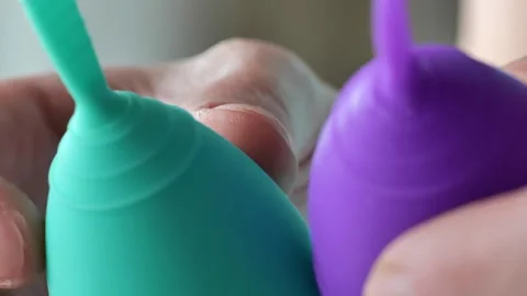 Silicone menstrual cups in hands. Zero vaste and reasonable hygiene Stock Footage 278367838