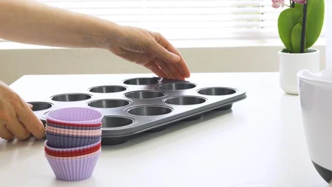 Silicone muffin cups close up. Placing liners on a muffin tray. Stock Footage 127746695