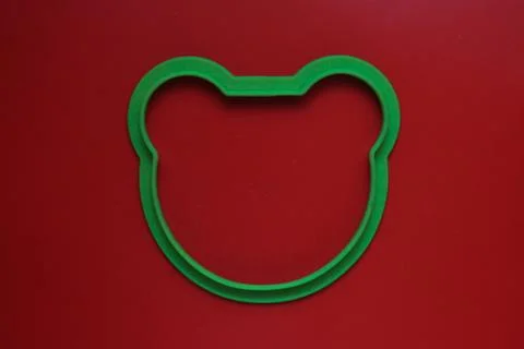 Silicone shape in the form of a bear's head on a red background Stock Photos